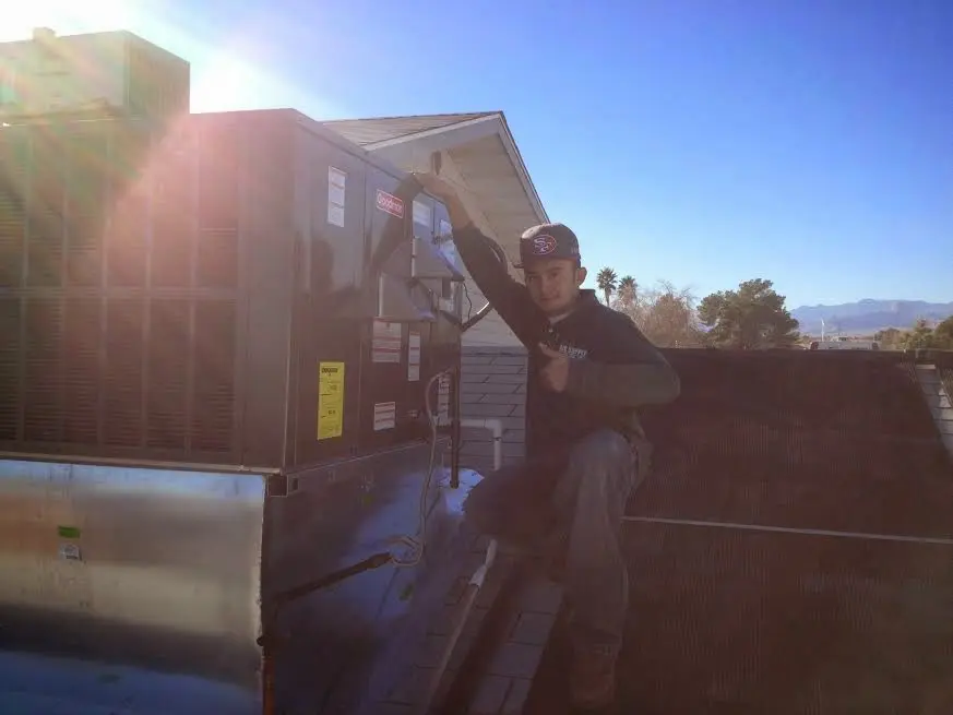 HVAC technician performing Heat Pump Repair on a rooftop unit in Jasmine Estates